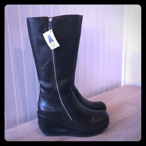 Tall black wedge boots